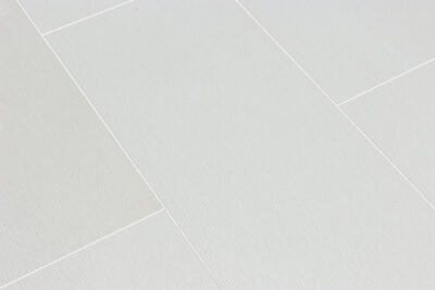 Cream textured tile with small brown fossils